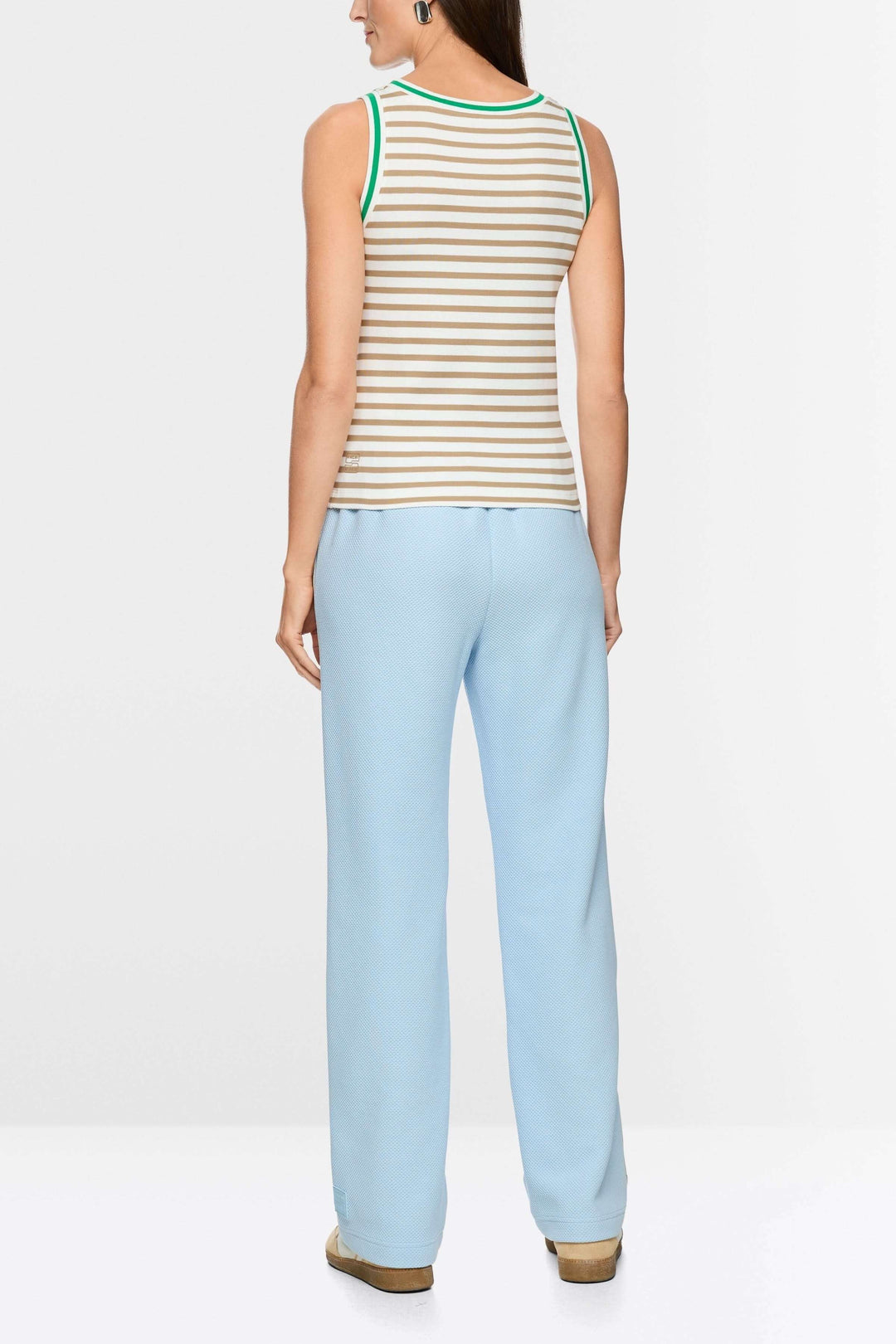 Camisole rayé en coton avec encolure ronde contrastante, silhouette sportive et moderne, portée avec pantalon bleu.