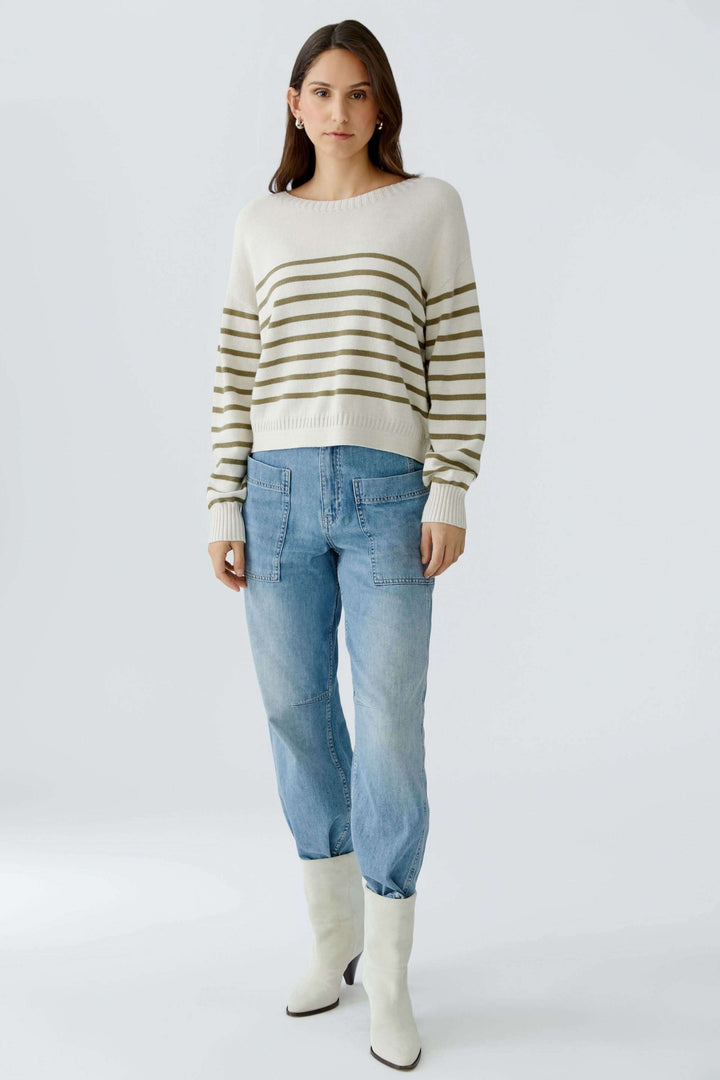 Femme portant un chandail à rayures en maille douce avec jeans, allure décontractée et moderne, encolure ronde, manches longues.