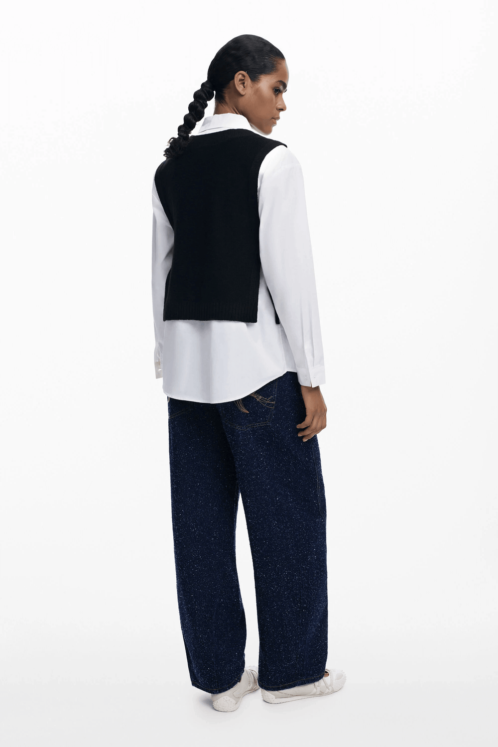 Femme portant une Chemise 2 en 1 avec chandail sans manches intégré, offrant un look superposé moderne et raffiné.