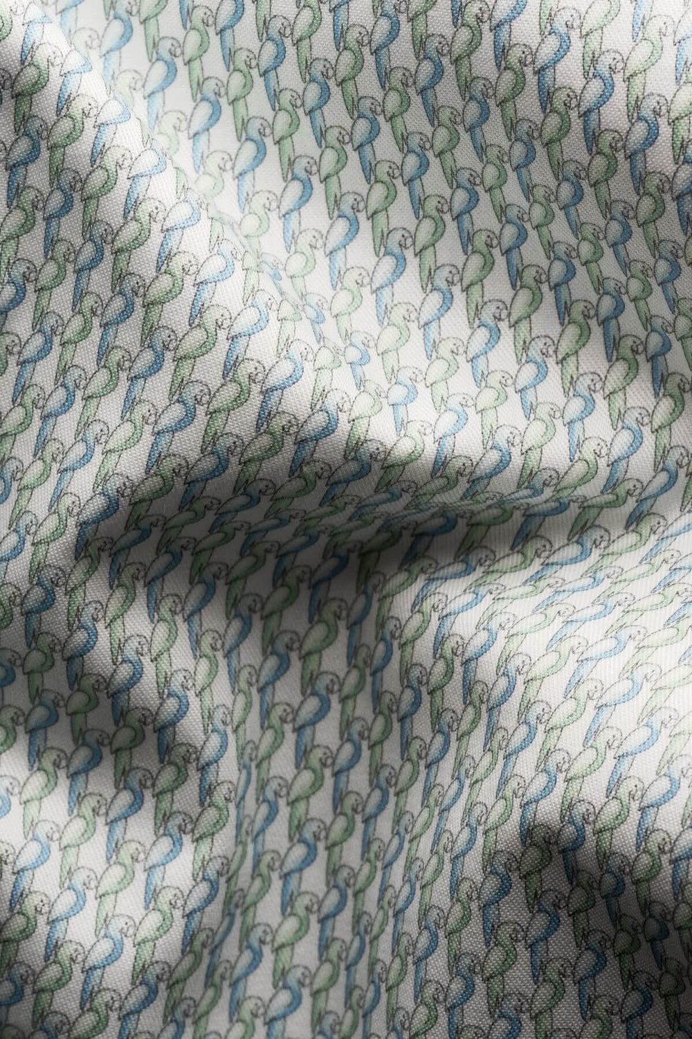 Tissu en coton avec imprimé perroquet en tons de vert pâle et bleu, idéal pour chemises élégantes.