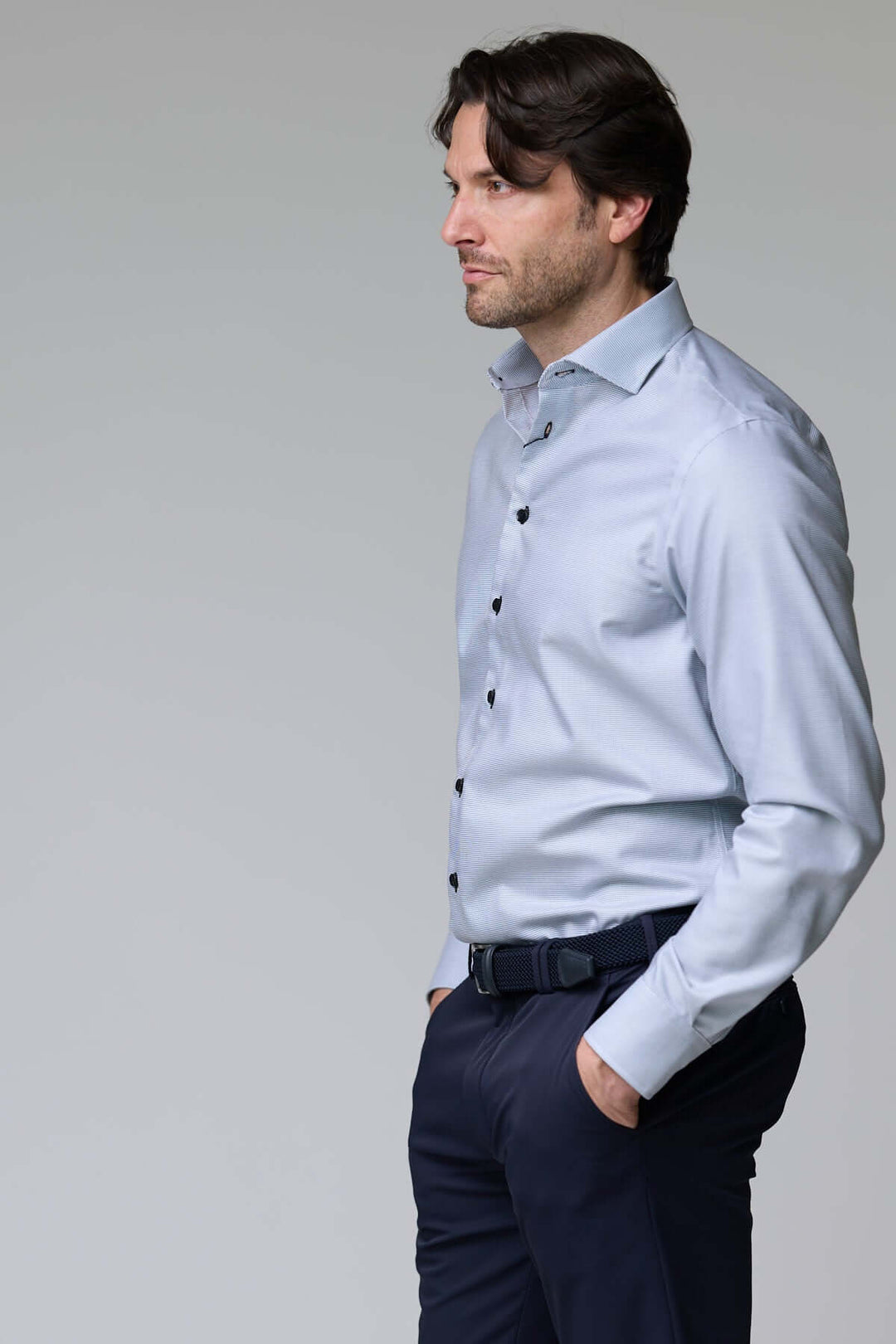 Homme portant une chemise à micro-motif texturé, manches longues, coupe ajustée, idéale pour bureau ou occasions chics.