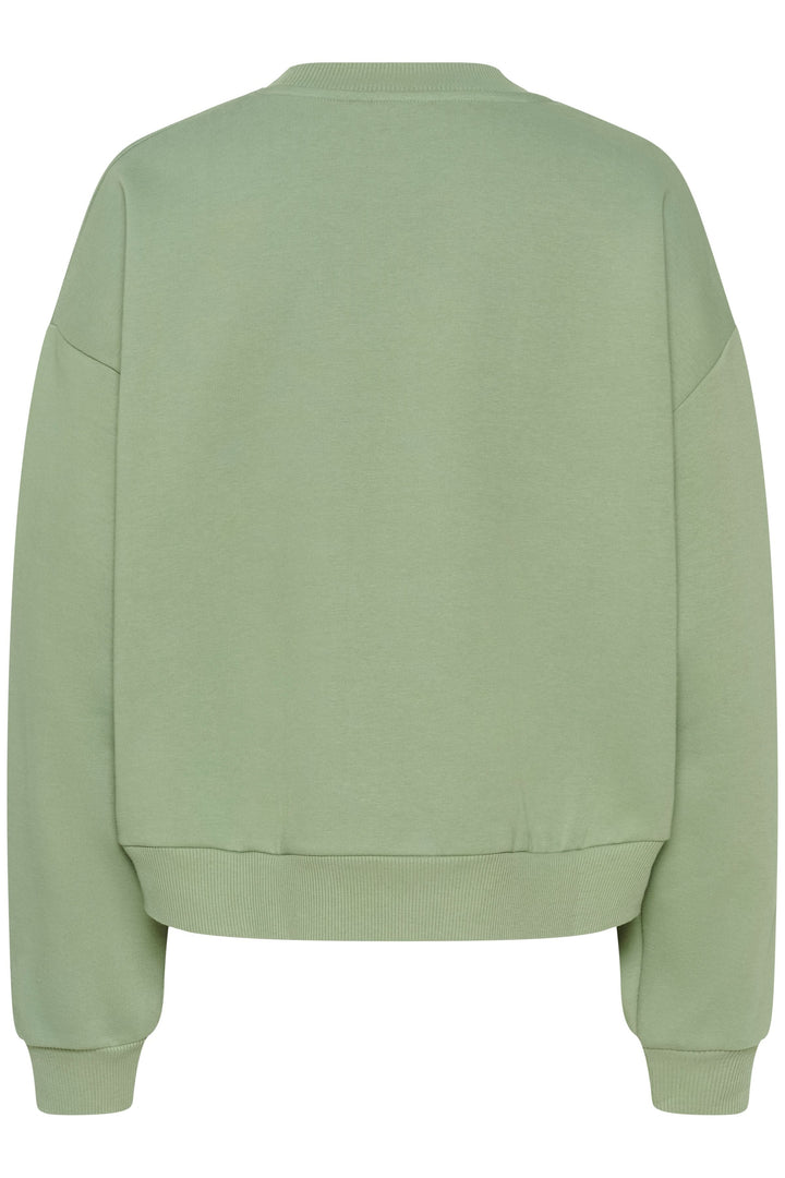 Coton ouaté Sussi vert style universitaire, coupe ample, encolure ronde, manches longues.