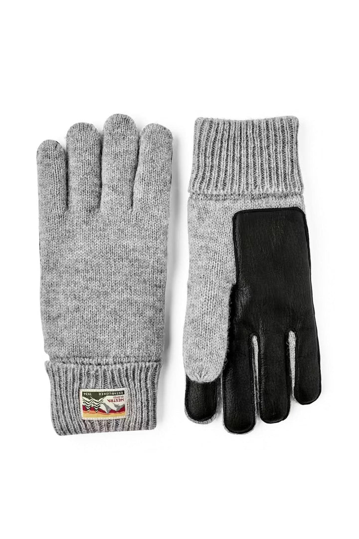 Ganst en maille pour une protection confortable, gris et noir, design souple, idéale pour temps froid. Décris moi le produit en français.