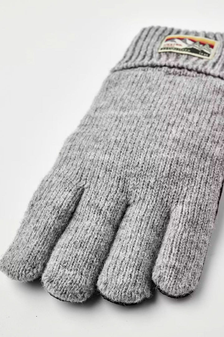 Ganst en maille gris offrant chaleur et flexibilité avec poignets côtelés, parfaits pour les journées fraîches. Décris moi le produit en français.