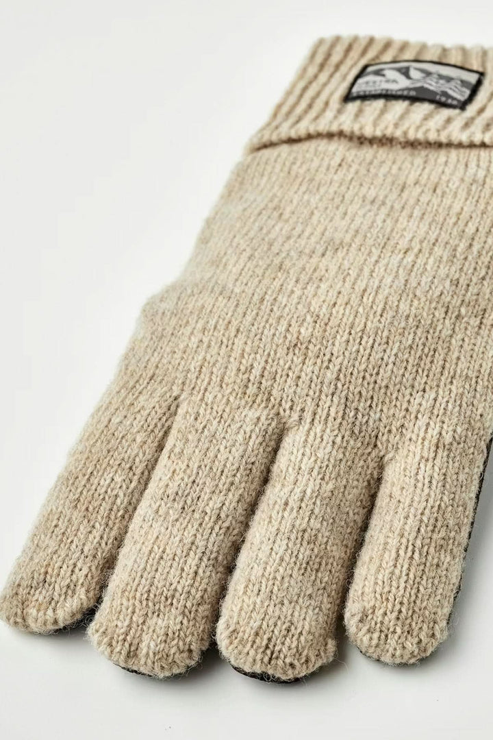 Gants en maille beige avec poignets côtelés, offrant confort et chaleur pour les journées fraîches. Décris moi le produit en français.