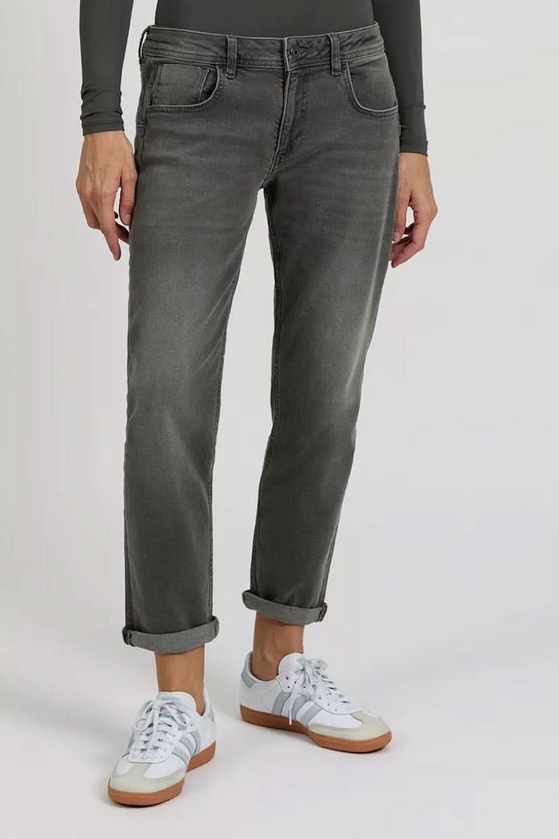 Jean Nina skinny en tissu extensible, poches arrondies, style chic ou décontracté, porté avec baskets blanches.