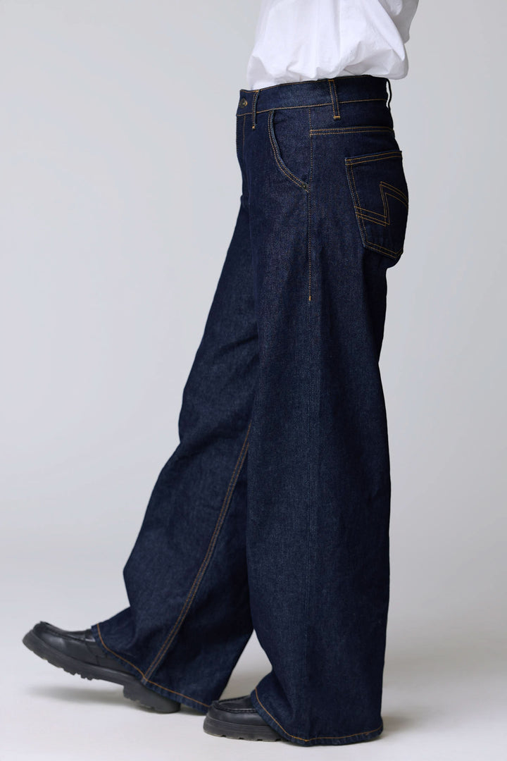 Jean à jambe large en denim rigide, style vintage avec surpiqûres contrastantes, coupe ample et droite offrant confort.