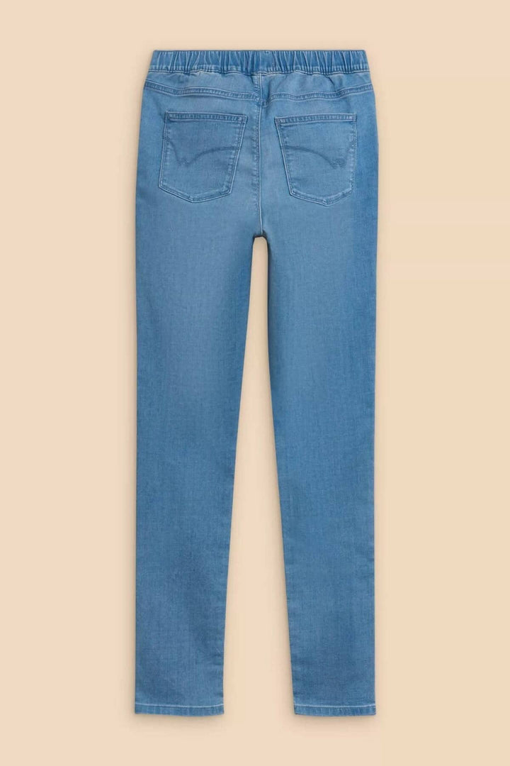 Back view of Janey jeans, featuring a comfortable elastic waistband and fitted design in light blue.