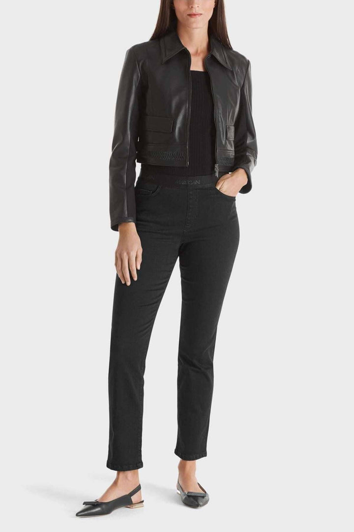 Jeans SIENA en coton bio avec ceinture élastique, modèle à cinq poches, délavé, porté avec une veste en cuir.