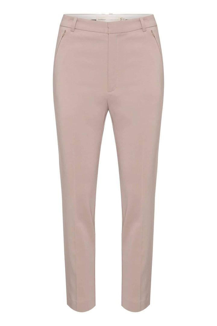 Pantalon Ziggi beige, coupe ajustée, en tissu coton confortable avec poches zippées, style décontracté et élégant.