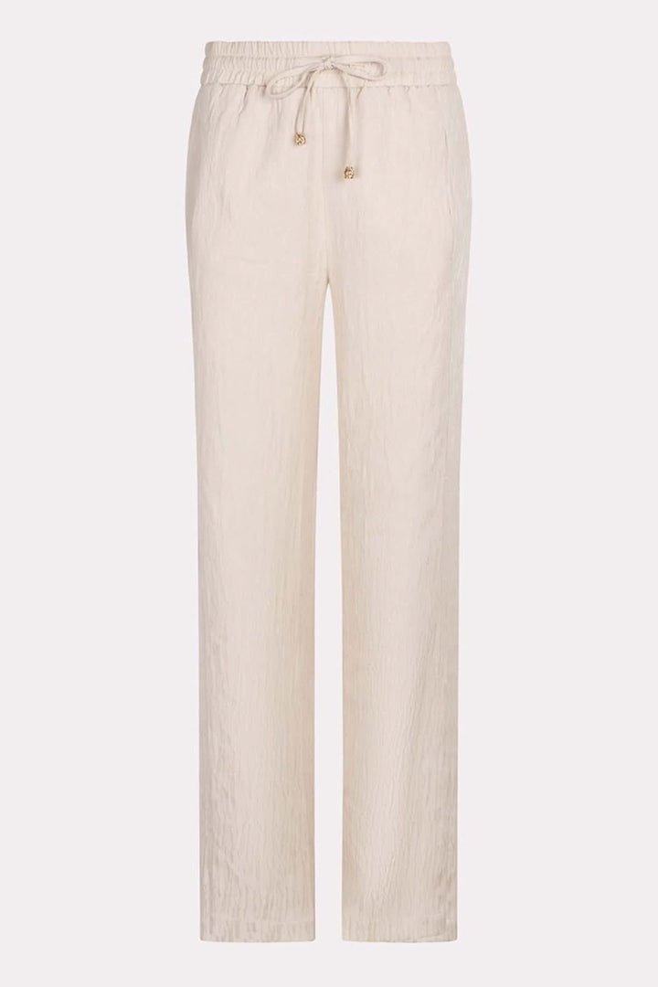 Pantalon ample en jacquard texturé, taille élastique, cordon ajustable, couleur beige.