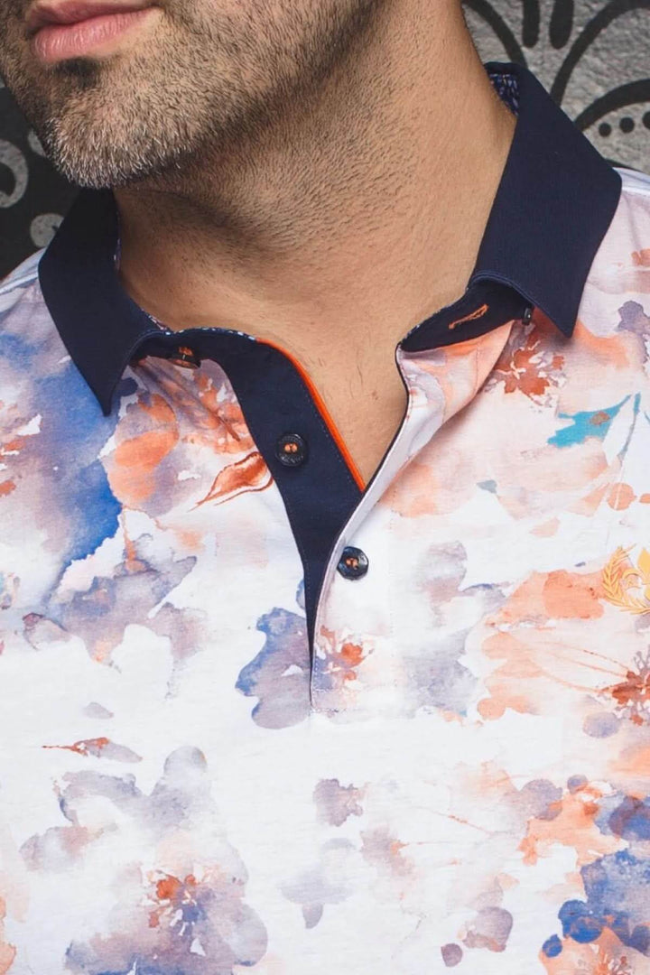 Polo Anzio floral aquarelle avec col contrastant et finitions soignées, parfait pour l'été.