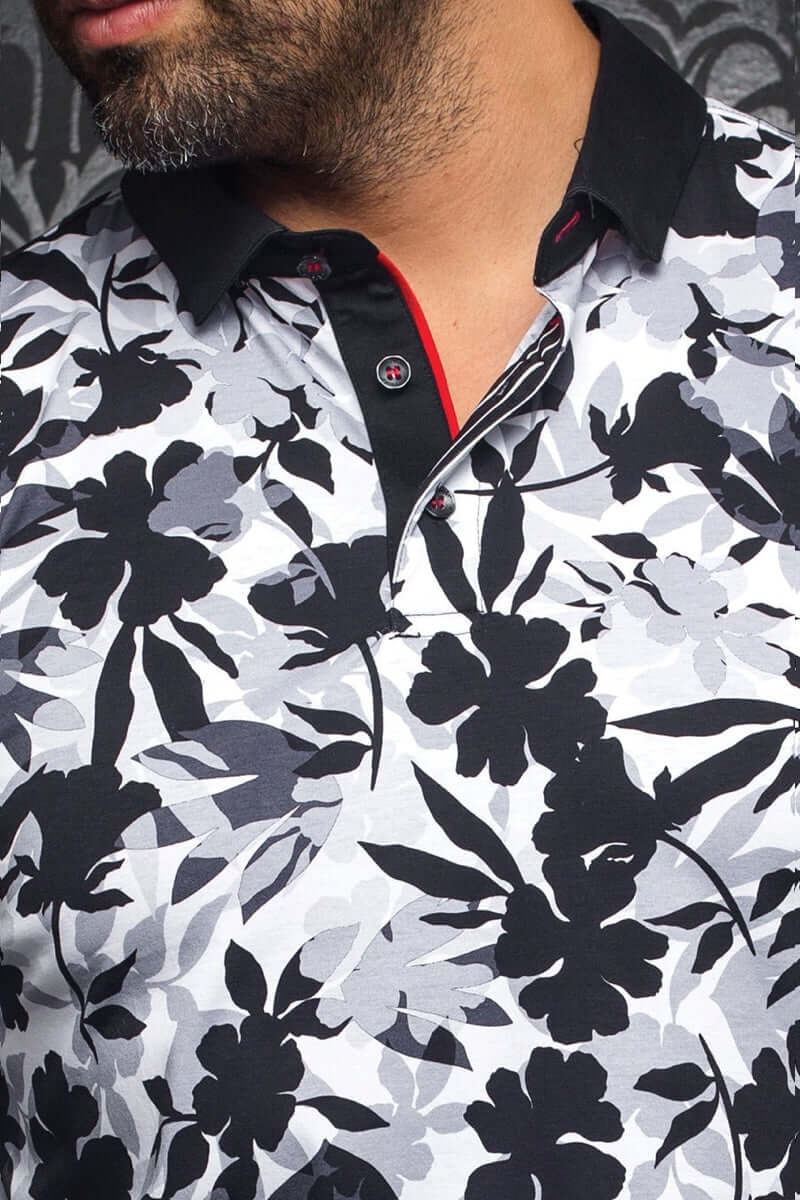 Polo Yavari à manches longues avec motif floral abstrait noir et blanc, col contrastant noir et rouge.
