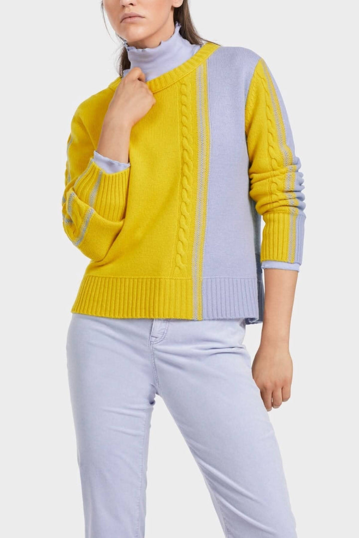 Pull tricoté bicolore en laine alpaga, couleur maïs et lavande, avec encolure ronde et motif asymétrique.
