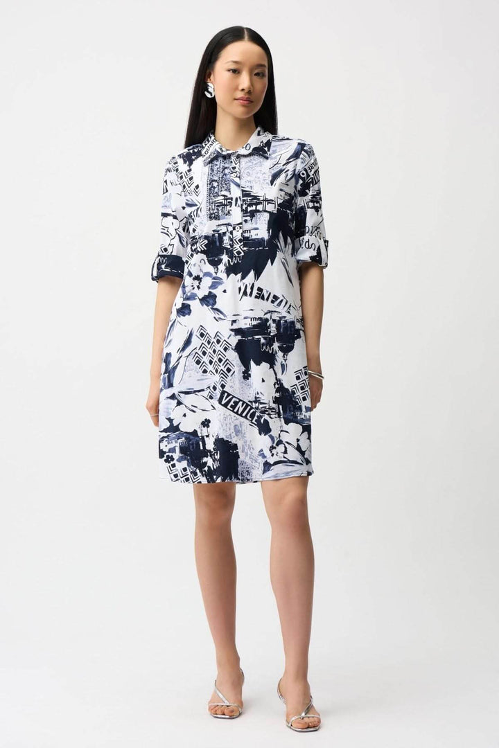 Femme portant une robe chemise imprimée avec un motif graphique urbain, coupe droite, col chemise, idéale pour un style quotidien.