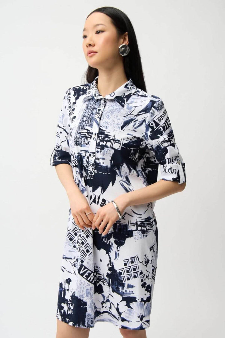Femme portant une robe chemise imprimée avec motif graphique urbain, coupe droite et col chemise, style polyvalent et confortable.