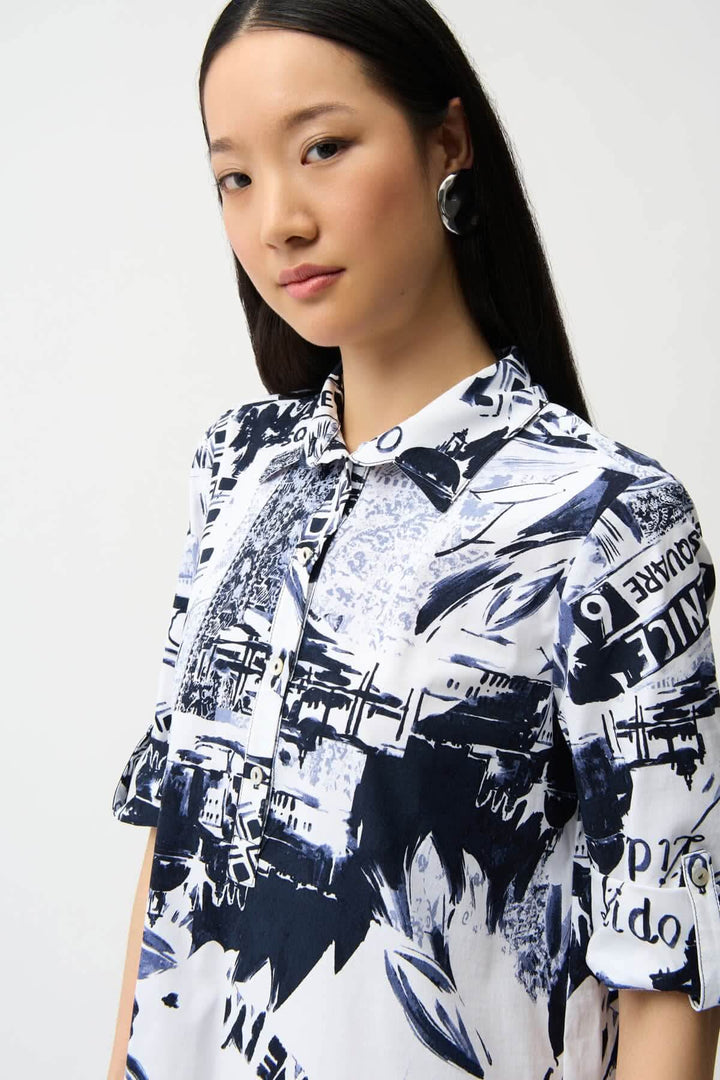 Femme portant une robe chemise imprimée avec un motif graphique urbain et col chemise structuré.