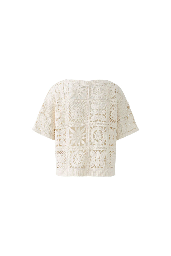 T-shirt crocheté à motifs géométriques, coupe courte et large, parfait pour un look bohème chic.