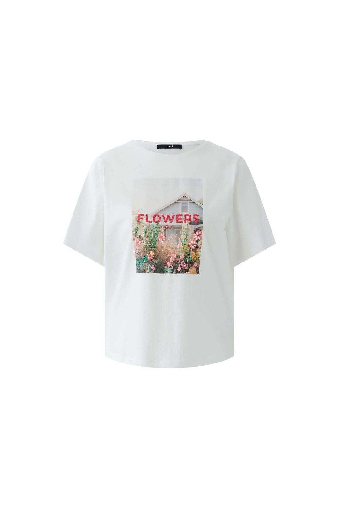 T-shirt imprimé graphique en coton blanc avec visuel artistique de fleurs colorées, coupe droite, manches courtes, mode contemporaine.