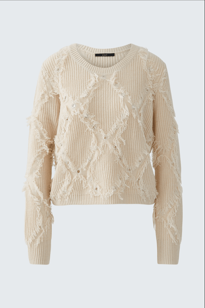 Tricot motif losange en laine avec franges et détails métalliques, coupe courte et décontractée, couleur beige.