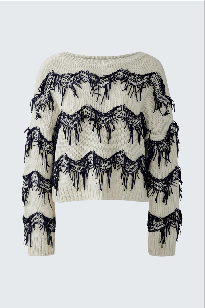 Tricot motif zigzag avec franges, coupe carrée et courte, encolure sous-marine. Mode texturée et décontractée en pur coton.