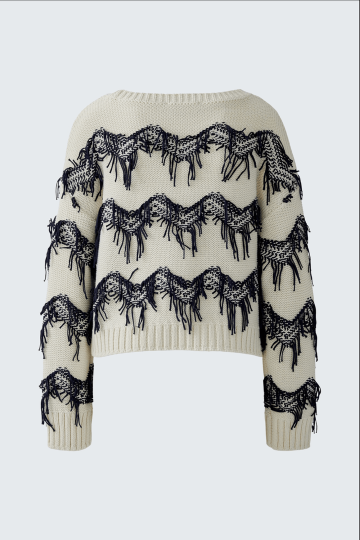 Tricot motif zigzag avec franges tricotées à la main, coupe carrée et courte, pur coton, moderne et décontracté.