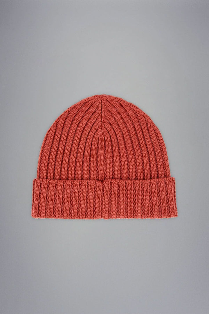 Bonnet en laine côtelée couleur corail, design intemporel et doux, parfait pour l'hiver.