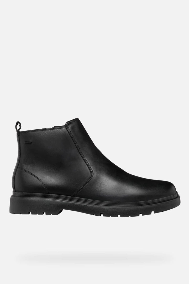 Vue latérale Botte Chelsea en cuir noir Geox pour homme avec détails élastiques et semelle antidérapante - Valérie Simon