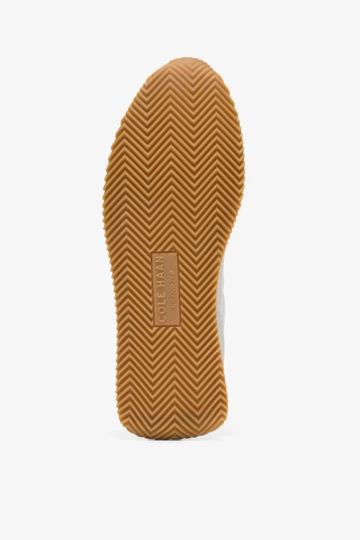 Side view of the Davie Runner leather and suede dress shoes for women by Cole Haan