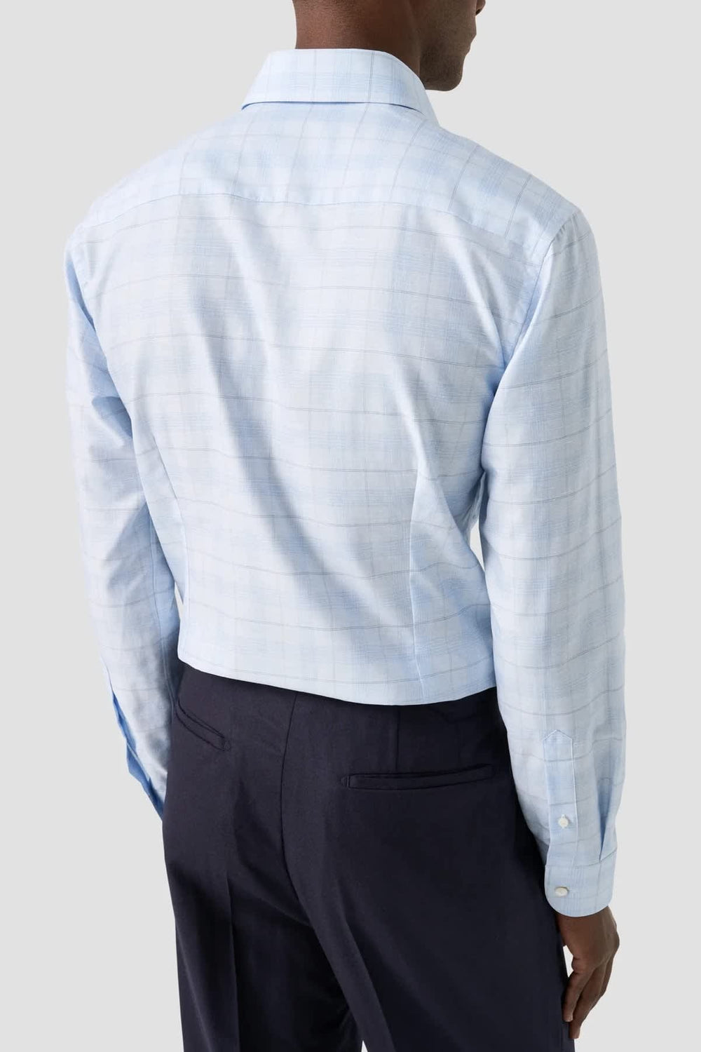 Close-up of a men's formal shirt with a subtle Eton check pattern in blue by Valérie Simon