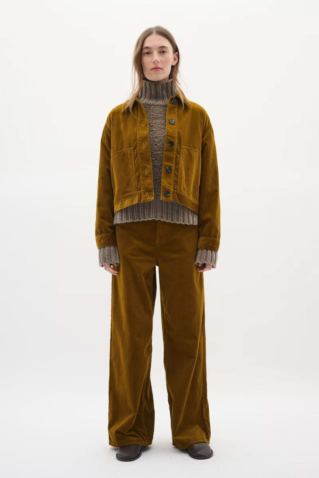 Veste en velours côtelé NanetteI portées avec un pull épais et un pantalon assorti pour un look rétro.