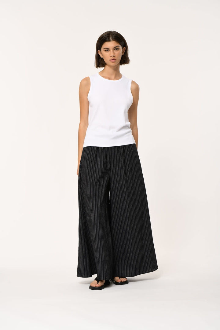 Front view of a high-neck black camisole Humility for women with a round neckline - Valérie Simon
