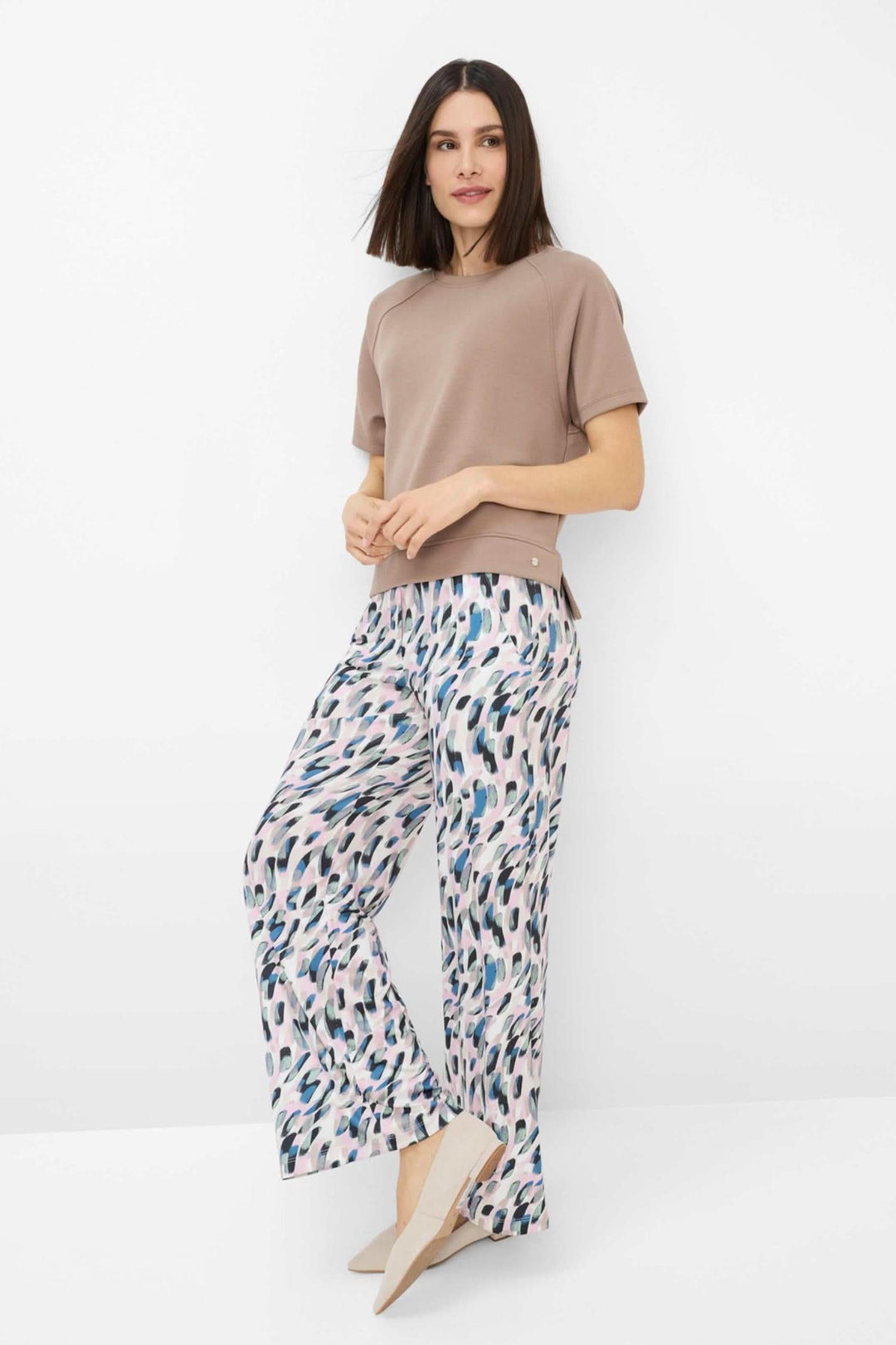 Sweatshirt moderne oversize beige avec pantalon fluide imprimé, look urbain et contemporain.