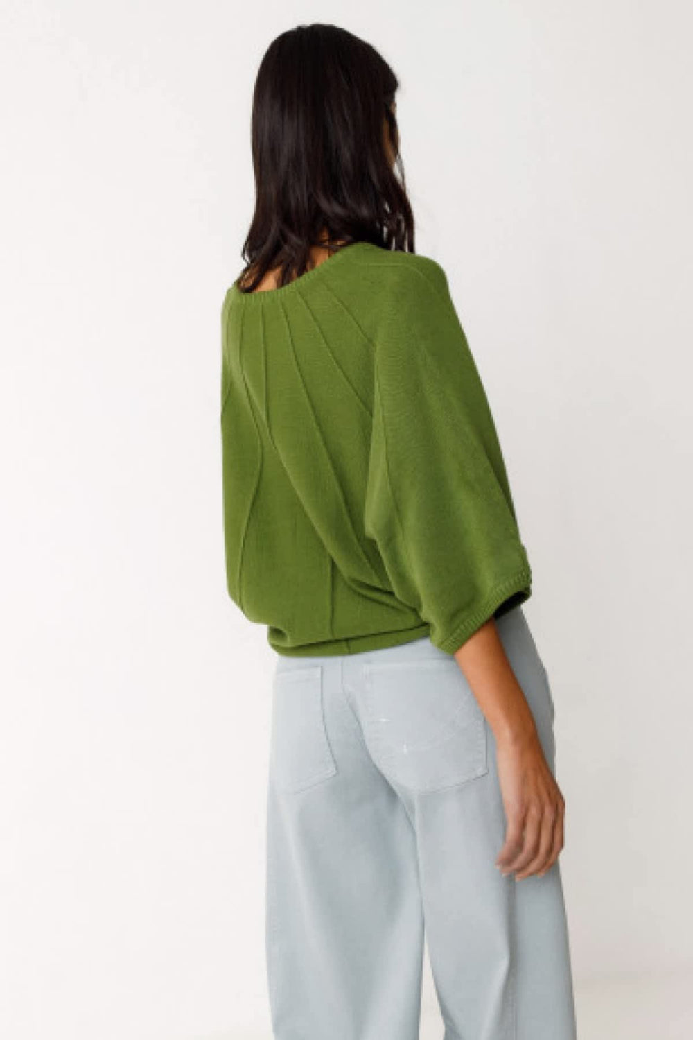Side view of the OLAIA-GOTS women's red SKFK sweater with a unique knitted pattern - Valérie Simon