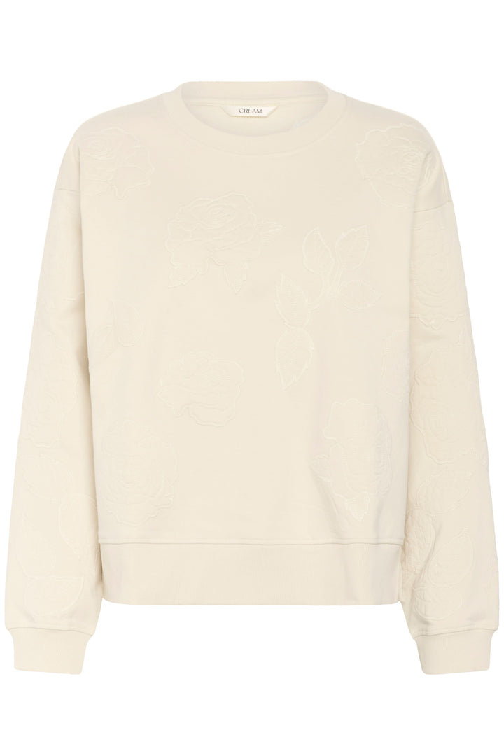 Coton ouaté Josie clair avec broderies florales ton sur ton, style élégant et confortable pour tenues décontractées.