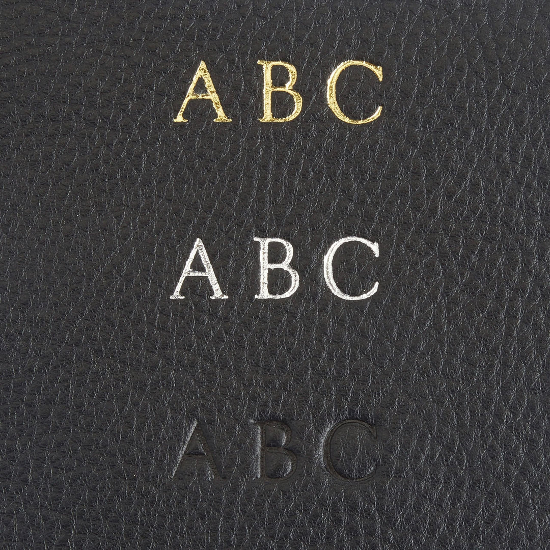 Monogram personalization options in gold, silver, and black on leather for a stylish touch.