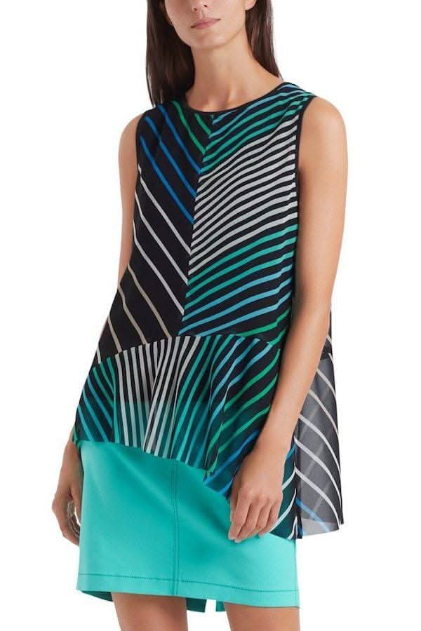 Camisole lignée aux motifs à rayures noires, vertes et bleues, portée avec une jupe turquoise.