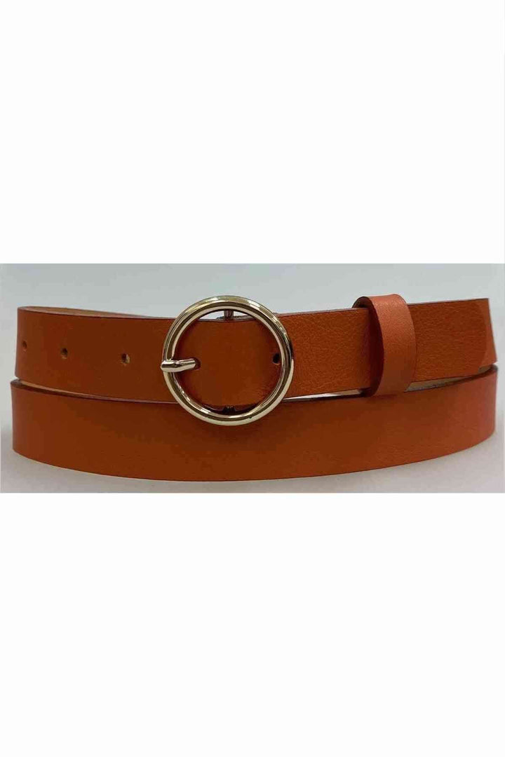 Ceinture en cuir orange avec anneau argenté, souple et élégante pour compléter vos tenues.