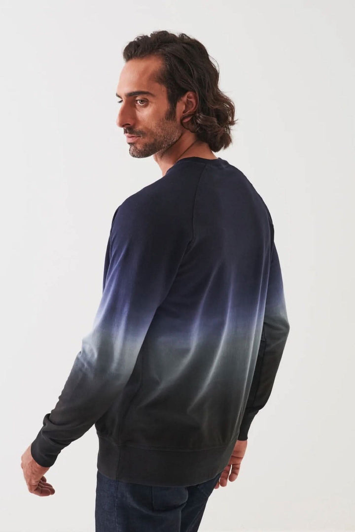 Homme portant un col rond en coton dégradé, vue de dos, avec un design moderne et élégant.