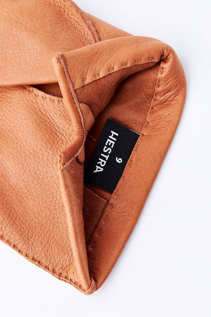 Intérieur d'un gant en cuir de cer frais avec étiquette Hestra, couleur marron.