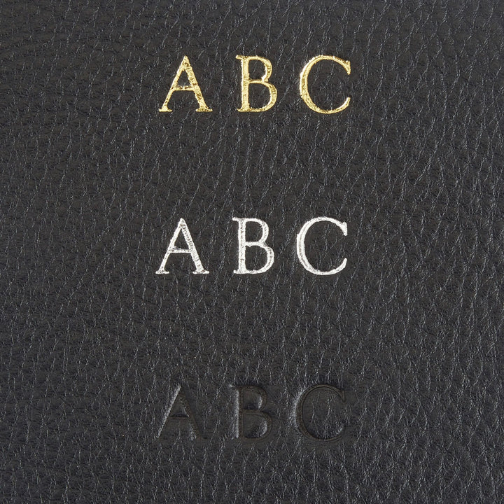 Monogram personalization options on leather wallet showcasing gold, silver, and blind embossed initials ABC.