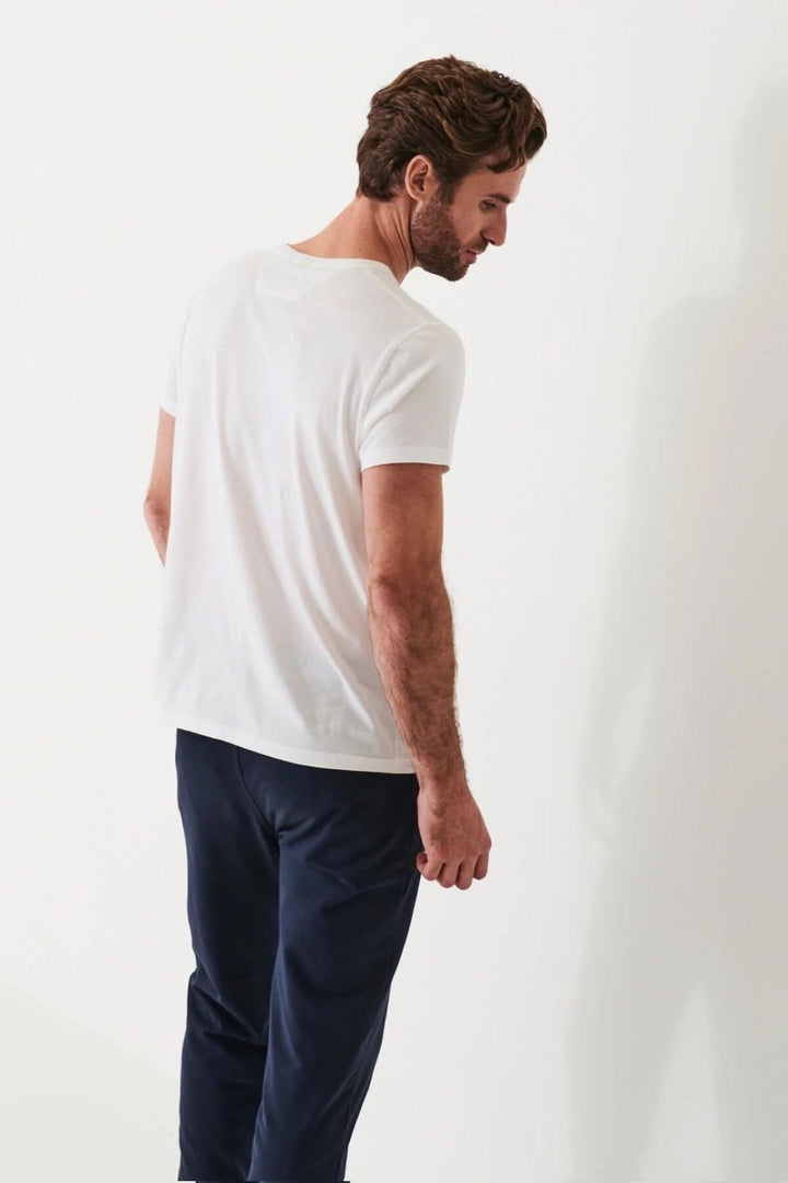 Homme portant un t-shirt léger en coton pima, vu de dos, avec un pantalon foncé.