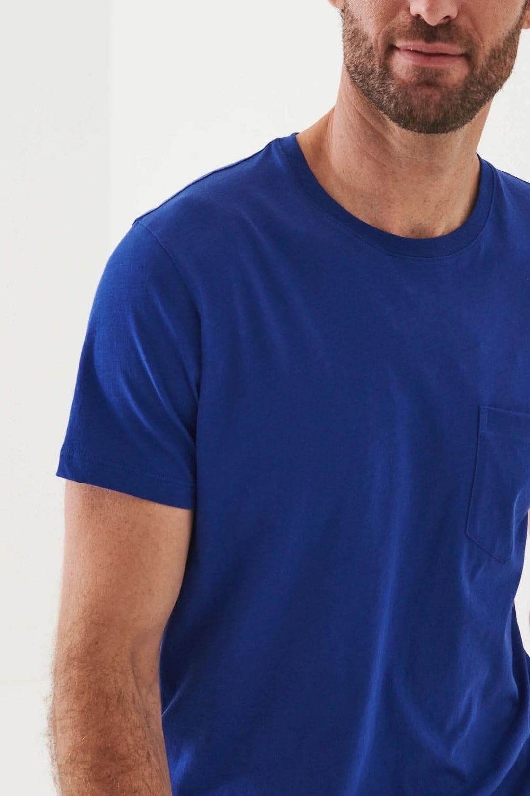 Homme portant un t-shirt léger en coton pima bleu avec poche, idéal pour les journées chaudes.