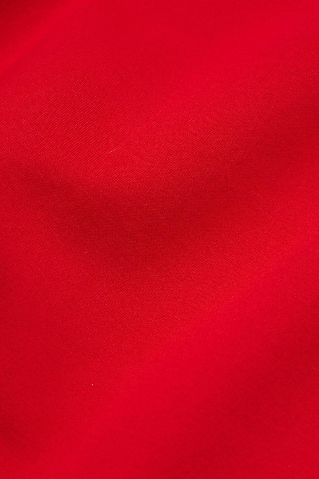 Tissu en jersey rouge vif, doux et épais, parfait pour des vêtements confortables et stylés.